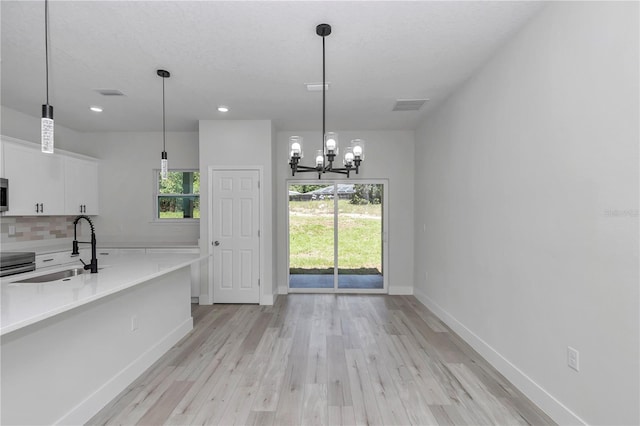 2705 W Royal Palm Dr, Citrus Springs, FL 34434 - unfurnished dining area featuring light wood-type flooring, a chandelier, and recessed lighting