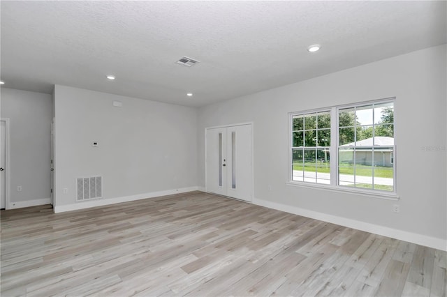 2705 W Royal Palm Dr, Citrus Springs, FL 34434 - empty room with recessed lighting, light wood-style flooring, and a textured ceiling