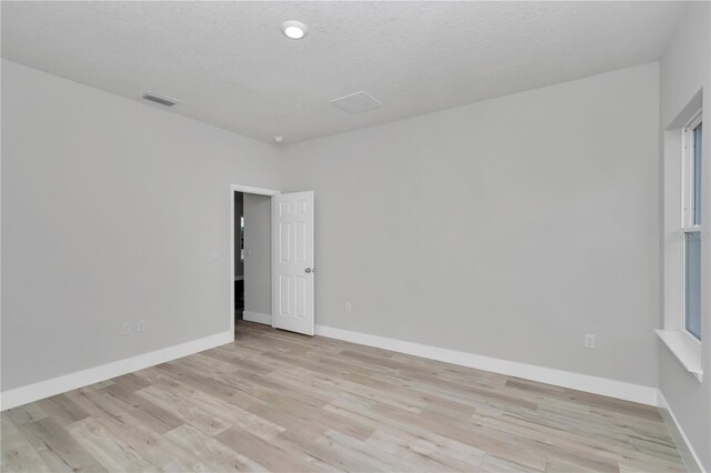 2705 W Royal Palm Dr, Citrus Springs, FL 34434 - spare room featuring light wood-style flooring and baseboards
