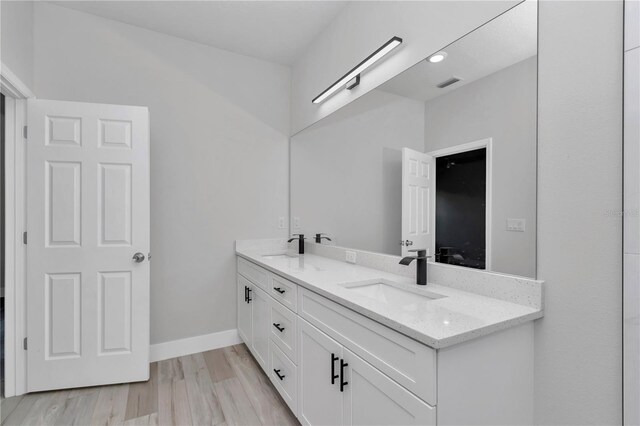 2705 W Royal Palm Dr, Citrus Springs, FL 34434 - full bath with double vanity and wood finished floors