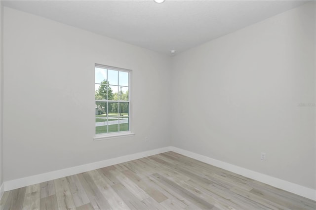 2705 W Royal Palm Dr, Citrus Springs, FL 34434 - empty room with baseboards and light wood finished floors