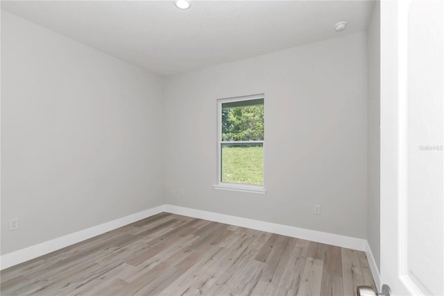 2705 W Royal Palm Dr, Citrus Springs, FL 34434 - spare room featuring light wood-style flooring and a smoke detector