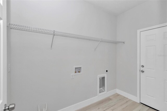2705 W Royal Palm Dr, Citrus Springs, FL 34434 - laundry room featuring electric dryer hookup, washer hookup, and light wood finished floors