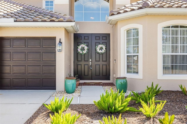 1178 Fraser Pine Blvd, Sarasota, FL 34240 - doorway to property featuring stucco siding, a tile roof, and concrete driveway