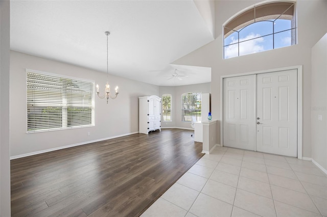 1178 Fraser Pine Blvd, Sarasota, FL 34240 - entryway with a chandelier, wood finished floors, baseboards, a high ceiling, and a ceiling fan