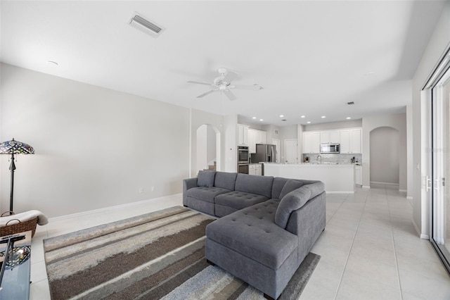 1178 Fraser Pine Blvd, Sarasota, FL 34240 - living room featuring arched walkways, ceiling fan, light tile patterned flooring, recessed lighting, and baseboards
