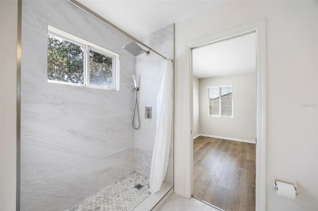 1178 Fraser Pine Blvd, Sarasota, FL 34240 - bathroom with tiled shower, baseboards, and wood finished floors