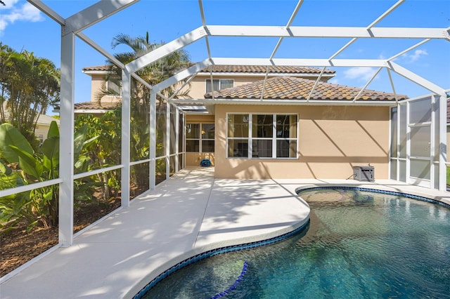 1178 Fraser Pine Blvd, Sarasota, FL 34240 - rear view of house with glass enclosure, a tile roof, a patio, and stucco siding