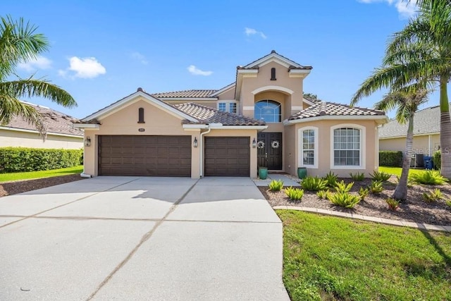1178 Fraser Pine Blvd, Sarasota, FL 34240 - mediterranean / spanish home featuring stucco siding, a garage, driveway, and a tile roof