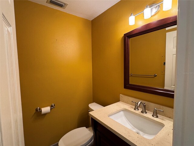 750 Island Way Unit 101, Clearwater Beach, FL 33767 - half bathroom featuring toilet and vanity