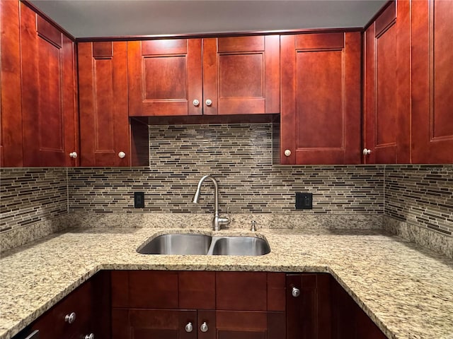 750 Island Way Unit 101, Clearwater Beach, FL 33767 - kitchen featuring reddish brown cabinets, a sink, and light stone counters