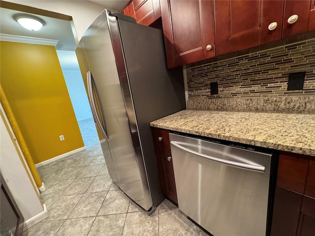 750 Island Way Unit 101, Clearwater Beach, FL 33767 - kitchen featuring appliances with stainless steel finishes, backsplash, crown molding, dark brown cabinets, and light stone counters