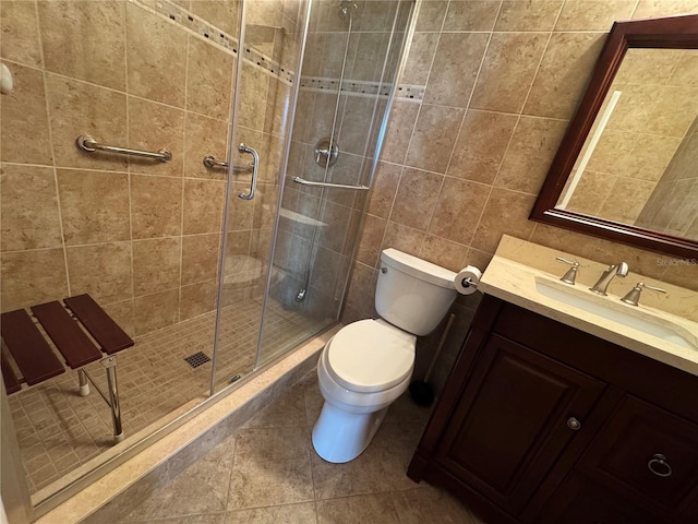 750 Island Way Unit 101, Clearwater Beach, FL 33767 - full bath featuring toilet, a shower stall, vanity, tile walls, and tile patterned floors