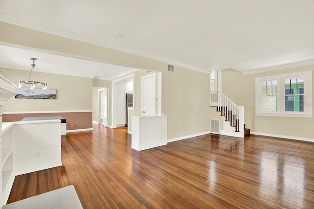 258 14th Ave NE, Saint Petersburg, FL 33701 - unfurnished living room featuring hardwood / wood-style floors, stairway, and ornamental molding