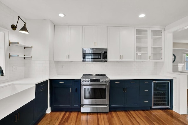 258 14th Ave NE, Saint Petersburg, FL 33701 - kitchen featuring appliances with stainless steel finishes, wine cooler, open shelves, white cabinetry, and light countertops