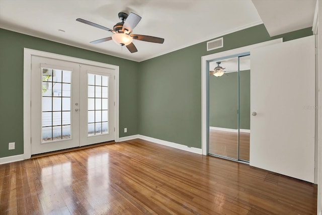 258 14th Ave NE, Saint Petersburg, FL 33701 - spare room with ceiling fan, french doors, wood finished floors, and crown molding