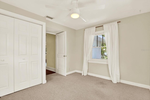 258 14th Ave NE, Saint Petersburg, FL 33701 - unfurnished bedroom featuring light carpet, a ceiling fan, and a closet