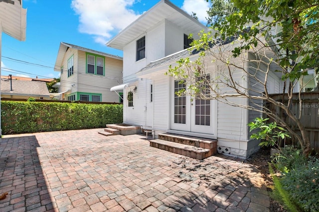 258 14th Ave NE, Saint Petersburg, FL 33701 - rear view of property with entry steps, french doors, and a patio area