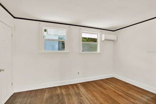 258 14th Ave NE, Saint Petersburg, FL 33701 - empty room featuring an AC wall unit, wood-type flooring, and crown molding