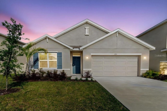 8210 Juning Cv, Wesley Chapel, FL 33545 - view of front of home with an attached garage, driveway, a yard, and stucco siding
