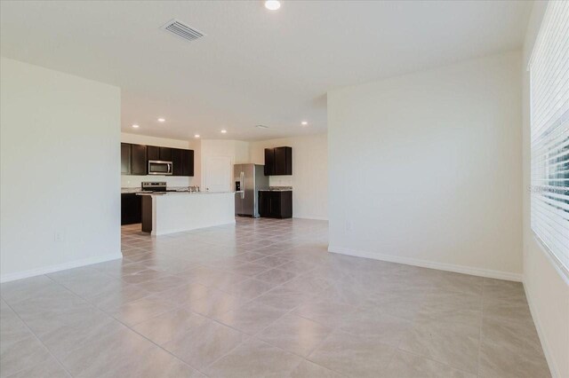 8210 Juning Cv, Wesley Chapel, FL 33545 - unfurnished living room featuring recessed lighting and light tile patterned floors