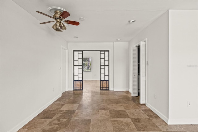 358 Suwanee Ave, Sarasota, FL 34243 - empty room featuring a ceiling fan and stone finish flooring