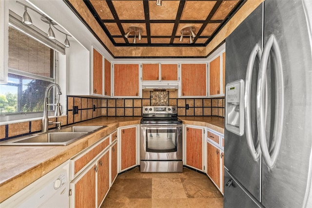358 Suwanee Ave, Sarasota, FL 34243 - kitchen featuring appliances with stainless steel finishes, under cabinet range hood, backsplash, light stone finish floors, and coffered ceiling
