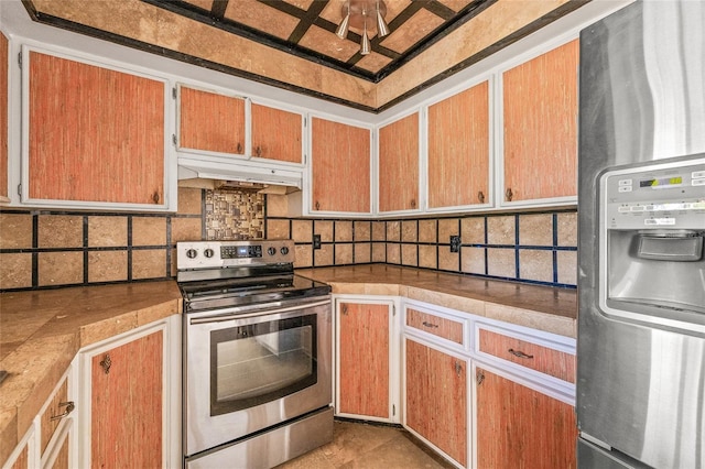 358 Suwanee Ave, Sarasota, FL 34243 - kitchen with stainless steel appliances, under cabinet range hood, backsplash, and light countertops