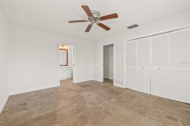 358 Suwanee Ave, Sarasota, FL 34243 - unfurnished bedroom featuring a closet, ensuite bathroom, stone finish flooring, and ceiling fan