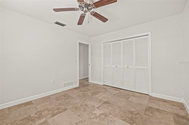 358 Suwanee Ave, Sarasota, FL 34243 - unfurnished bedroom with stone finish flooring, a closet, and a ceiling fan