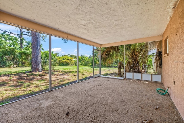 358 Suwanee Ave, Sarasota, FL 34243 - unfurnished sunroom with view of wooded area