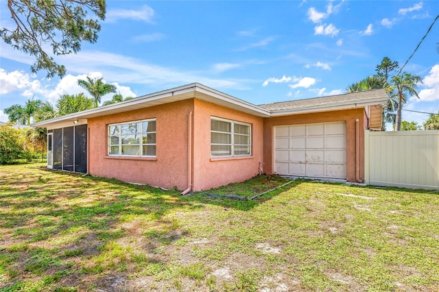 358 Suwanee Ave, Sarasota, FL 34243 - view of side of home featuring a sunroom, a garage, and stucco siding