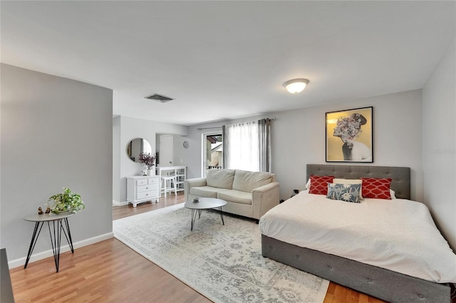 4215 E Bay Dr Unit 1801E, Clearwater, FL 33764 - bedroom featuring wood finished floors and baseboards