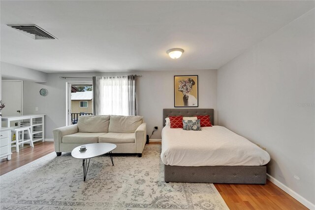 4215 E Bay Dr Unit 1801E, Clearwater, FL 33764 - bedroom featuring wood finished floors and baseboards