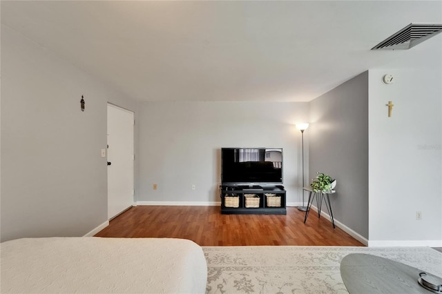 4215 E Bay Dr Unit 1801E, Clearwater, FL 33764 - bedroom with wood finished floors and baseboards