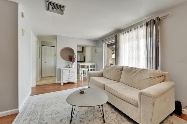 4215 E Bay Dr Unit 1801E, Clearwater, FL 33764 - living room featuring light wood-type flooring and baseboards