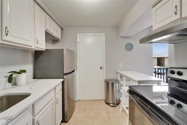 4215 E Bay Dr Unit 1801E, Clearwater, FL 33764 - kitchen with stainless steel appliances, exhaust hood, white cabinetry, light tile patterned floors, and light stone countertops