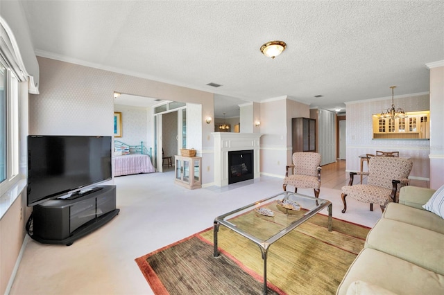 100 Bluff View Dr Unit 511C, Belleair Bluffs, FL 33770 - living area with wallpapered walls, crown molding, a chandelier, a textured ceiling, and a glass covered fireplace