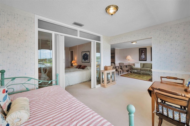 100 Bluff View Dr Unit 511C, Belleair Bluffs, FL 33770 - carpeted bedroom featuring wallpapered walls and a textured ceiling