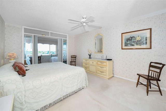 100 Bluff View Dr Unit 511C, Belleair Bluffs, FL 33770 - bedroom with a textured ceiling, light carpet, access to outside, a ceiling fan, and wallpapered walls