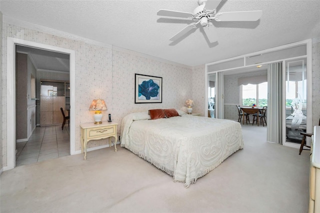 100 Bluff View Dr Unit 511C, Belleair Bluffs, FL 33770 - carpeted bedroom featuring access to outside, wallpapered walls, crown molding, a textured ceiling, and a ceiling fan
