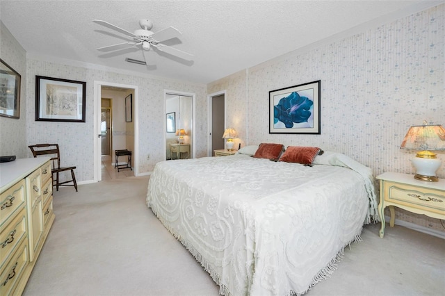 100 Bluff View Dr Unit 511C, Belleair Bluffs, FL 33770 - bedroom featuring wallpapered walls, light carpet, a closet, a textured ceiling, and a ceiling fan