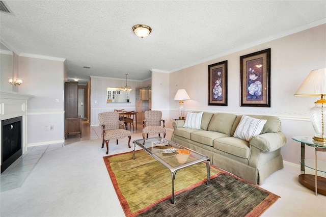 100 Bluff View Dr Unit 511C, Belleair Bluffs, FL 33770 - living area with a chandelier, ornamental molding, a textured ceiling, a fireplace with flush hearth, and light carpet
