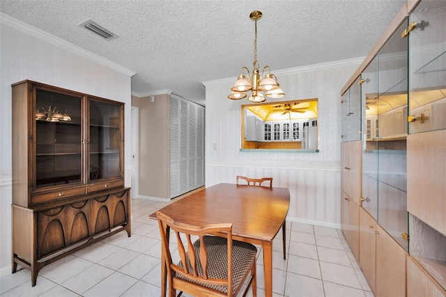 100 Bluff View Dr Unit 511C, Belleair Bluffs, FL 33770 - dining space with a chandelier, crown molding, light tile patterned floors, wallpapered walls, and a textured ceiling