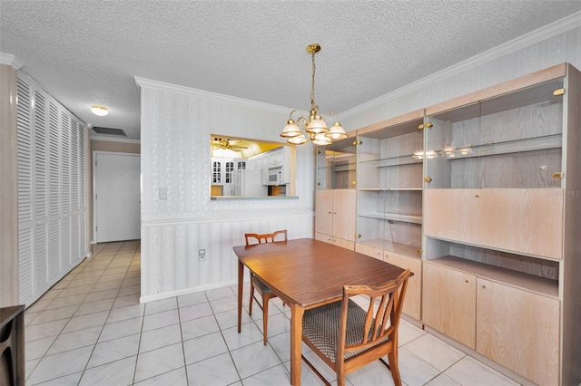 100 Bluff View Dr Unit 511C, Belleair Bluffs, FL 33770 - dining room featuring ornamental molding, a chandelier, a textured ceiling, light tile patterned floors, and ceiling fan