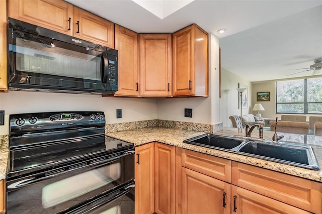 2621 Cove Cay Dr Unit 302, Clearwater, FL 33760 - kitchen with black appliances, open floor plan, ceiling fan, light stone counters, and tile patterned flooring