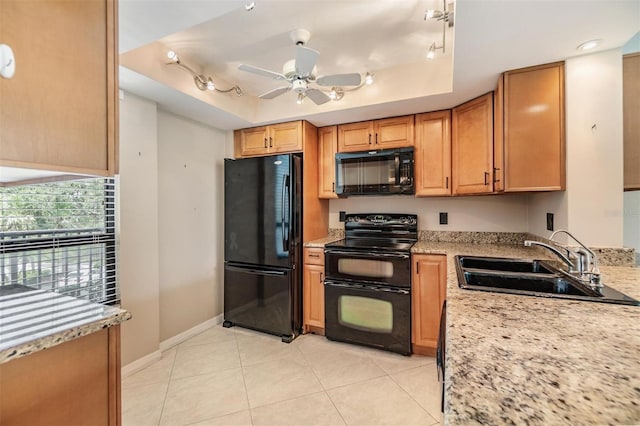 2621 Cove Cay Dr Unit 302, Clearwater, FL 33760 - kitchen featuring black appliances, a tray ceiling, ceiling fan, light tile patterned flooring, and rail lighting