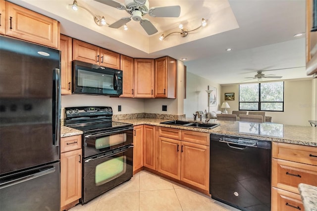 2621 Cove Cay Dr Unit 302, Clearwater, FL 33760 - kitchen with black appliances, a ceiling fan, light tile patterned flooring, a raised ceiling, and light stone counters