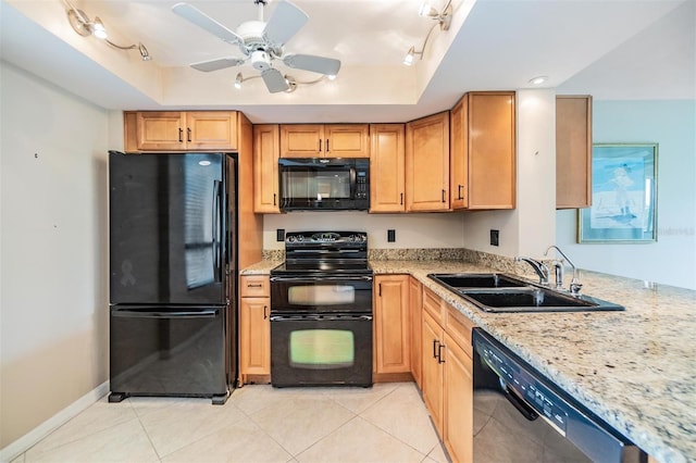 2621 Cove Cay Dr Unit 302, Clearwater, FL 33760 - kitchen featuring black appliances, a raised ceiling, rail lighting, and light stone countertops