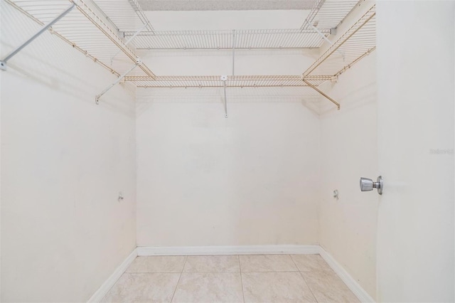2621 Cove Cay Dr Unit 302, Clearwater, FL 33760 - walk in closet with light tile patterned floors